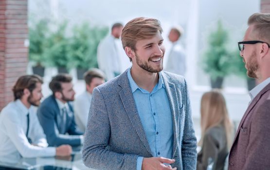 two business men talking standing in the office . photo with copy space