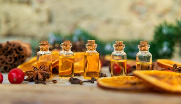 Christmas essential oils in small bottles. Selective focus. Nature.