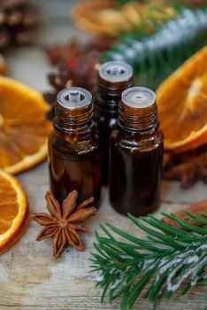 Christmas essential oils in small bottles. Selective focus. Nature.