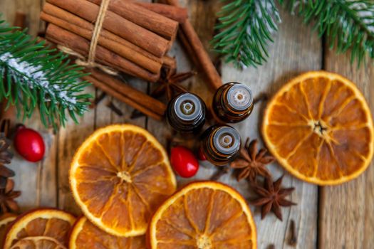 Christmas essential oils in small bottles. Selective focus. Nature.