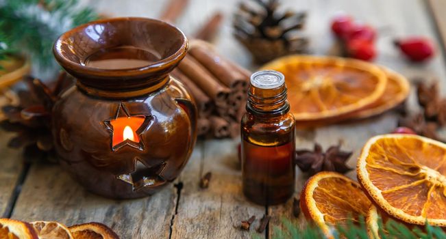 Christmas essential oils in small bottles. Selective focus. Nature.