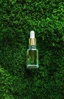 Cosmetics in a bottle and essential oils on moss. Natural spa. Selective focus. Nature.