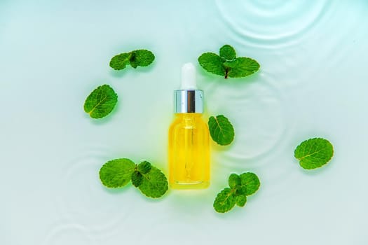 Cosmetics in a bottle in water, skin hydration concept. Selective focus. Nature.