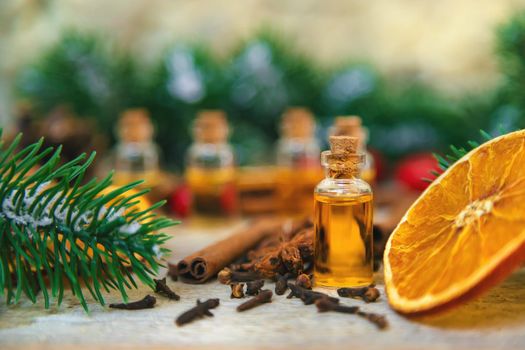 Christmas essential oils in small bottles. Selective focus. Nature.