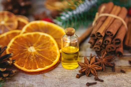 Christmas essential oils in small bottles. Selective focus. Nature.