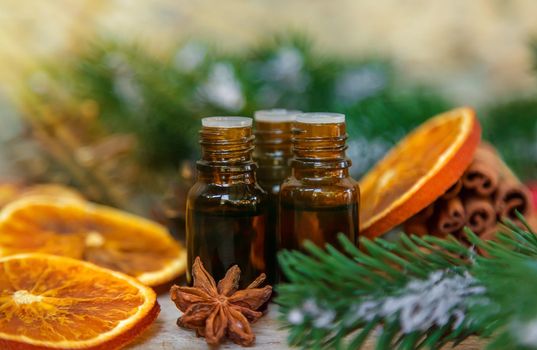 Christmas essential oils in small bottles. Selective focus. Nature.