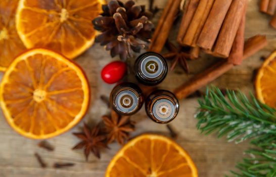 Christmas essential oils in small bottles. Selective focus. Nature.