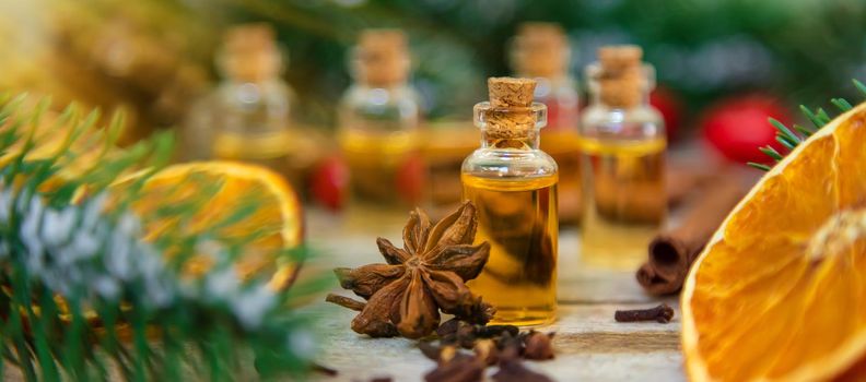 Christmas essential oils in small bottles. Selective focus. Nature.