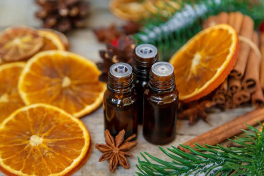 Christmas essential oils in small bottles. Selective focus. Nature.