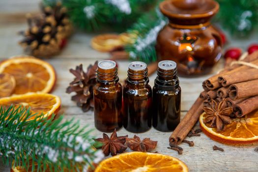 Christmas essential oils in small bottles. Selective focus. Nature.