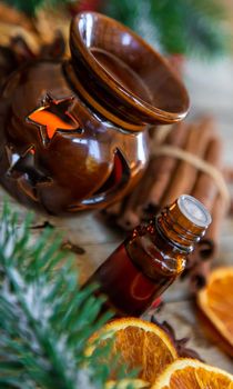 Christmas essential oils in small bottles. Selective focus. Nature.