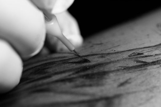 Tattoo needle penetrates the skin and insert the ink.