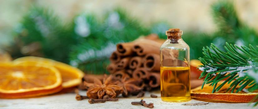 Christmas essential oils in small bottles. Selective focus. Nature.