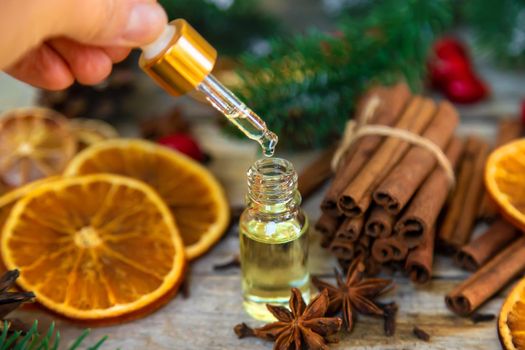 Christmas essential oils in small bottles. Selective focus. Nature.