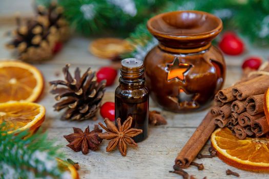 Christmas essential oils in small bottles. Selective focus. Nature.