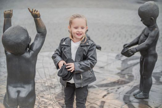 little girl is playing in the city square