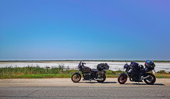 motorcycles parked on the side of the road during a trip to Camargue near Lake Sale