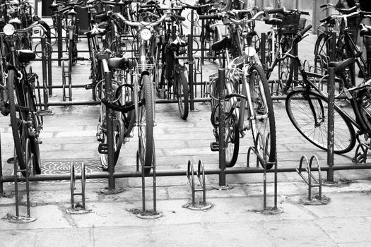 Old vintage bikes parked on the edge of the road.