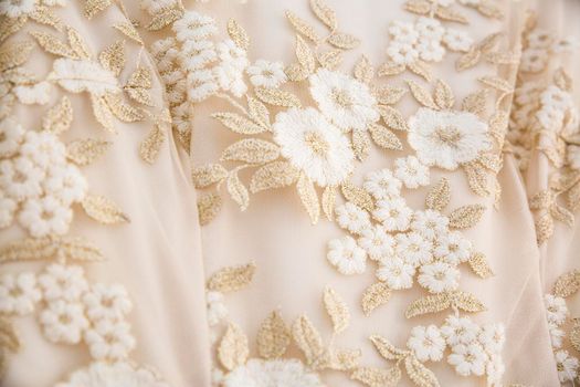 detail of a wedding dress with embroidered flowers