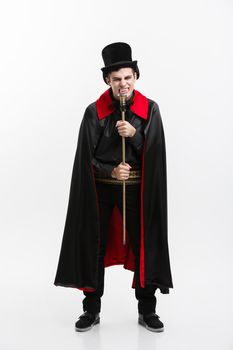 Vampire Halloween Concept - Full length Portrait of handsome caucasian Vampire in black and red halloween costume