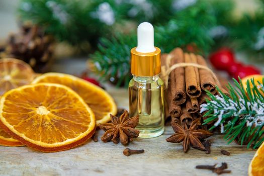 Christmas essential oils in small bottles. Selective focus. Nature.