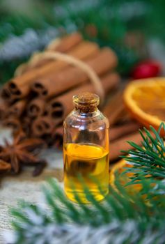 Christmas essential oils in small bottles. Selective focus. Nature.