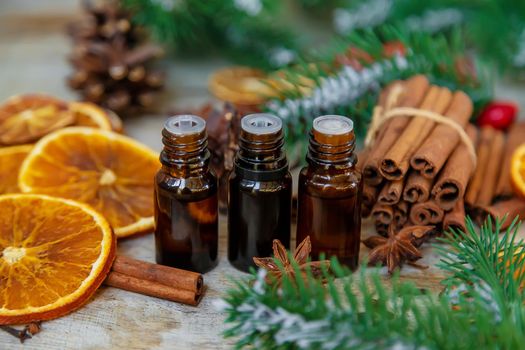 Christmas essential oils in small bottles. Selective focus. Nature.
