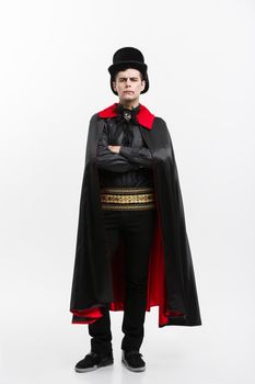 Vampire Halloween Concept - Full lenght Portrait of handsome caucasian Vampire in black and red halloween costume