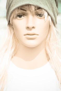 face of Female doll with grey hat.