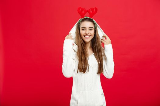 Christmas Concept - Young attractive caucasian lady wear reindeer hairband celebrating in Christmas day.
