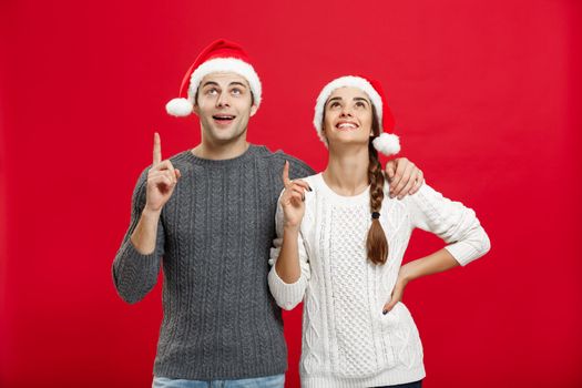 Christmas Concept - portrait lovely young couple finger on side well use for presentation or montage.