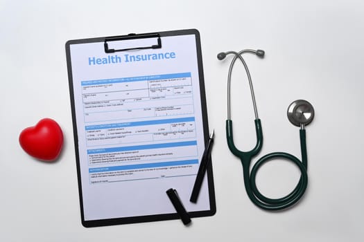 Stethoscope, medical report and heart on white background. Cardiology, healthcare and medical concept.