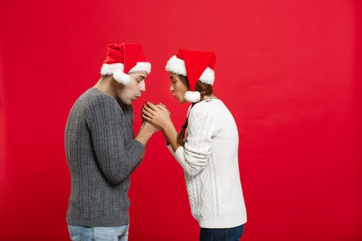 Christmas Concept - young stylish couple holding hand each other in winter.
