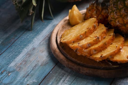 Fresh ripe pineapple on wooden plate. Close up, Tropical fruits, Summer concept.