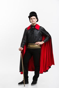 Vampire Halloween Concept - Full lenght Portrait of handsome caucasian Vampire in black and red halloween costume