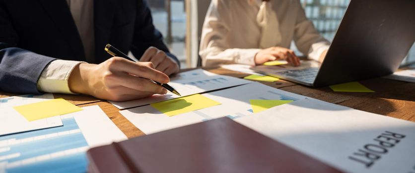 Businessman working analyzing and calculate expense financial annual report.