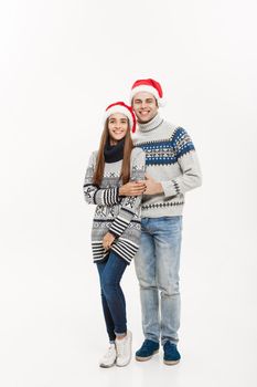 Christmas concept - Full-length Young attractive caucasian couple giving a hug celebrating for Christmas day