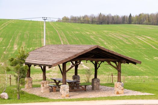 Wooden gazebo standing on the territory near the estate.