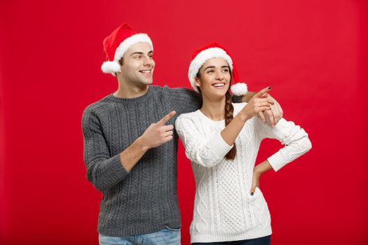Christmas Concept - portrait lovely young couple finger on side well use for presentation or montage.