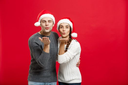 Christmas Concept - portrait lovely couple blowing wish to camera in Christmas day.