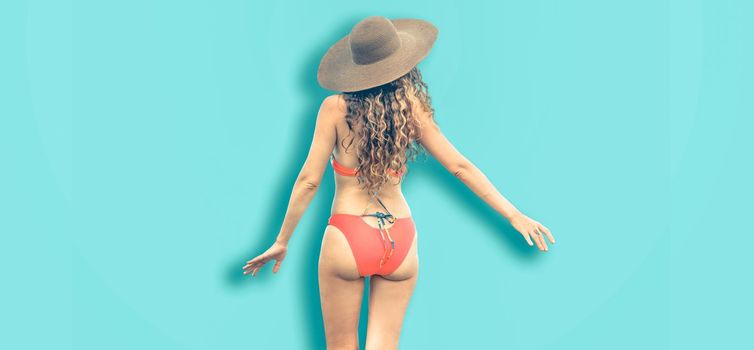 Beautiful young sexy woman in swimsuit posing on color background. Summer advertising.