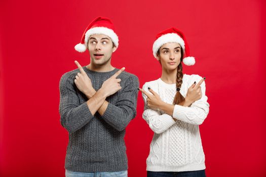 Christmas Concept - portrait lovely young couple finger on side well use for presentation or montage.