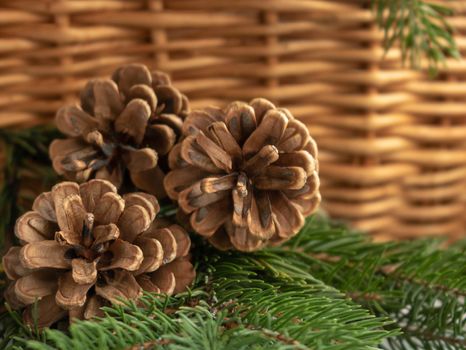 pine cones in a wicker basket on a brown background.chrismas holidays.