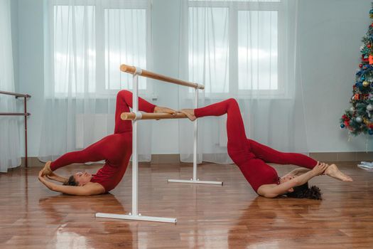 I train with a friend. Two young women train together in a bright training room near a choreographic machine