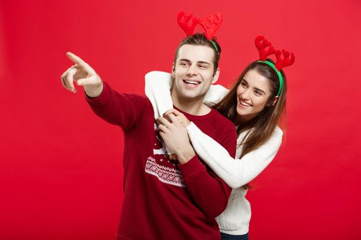 Christmas Concept - portrait lovely young couple finger on side well use for presentation or montage.