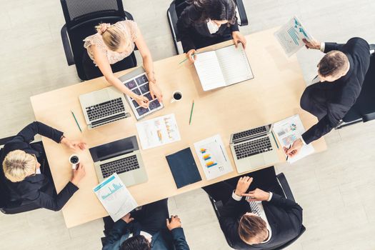 Business people group meeting shot from top view in office . Profession businesswomen, businessmen and office workers working in team conference with project planning document on meeting table .