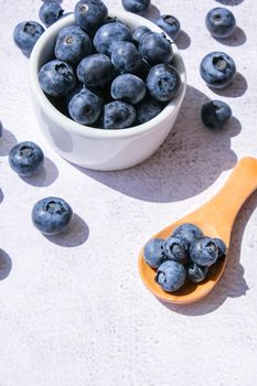 Fresh blueberries background with copy space for your text. Blueberry antioxidant organic superfood in a bowl concept for healthy eating and nutrition. Harvesting concept. Vegan Vegetarian