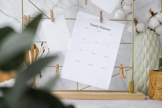 YEARLY PLANNER Cards and posters mock ups on grid board. Copy space. Home office desktop. Freelance bloggers workplace. Brushes and palette tools Creative