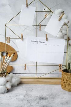 MONTHLY PLANNER Cards and posters mock ups on grid board. Copy space. Home office desktop. Freelance bloggers workplace. Brushes and palette tools Creative