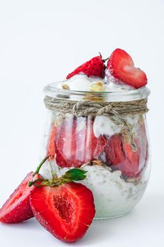 Healthy breakfast. Oatmeal Granola with greek yogurt and nuts strawberry muesli in jars on light background. Vegan, vegetarian and weight loss diet concept. Detox menu. Healthy eating food